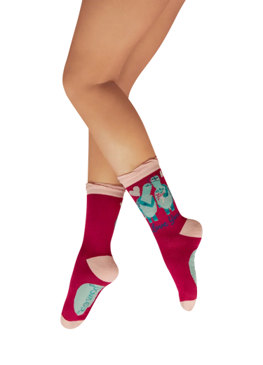 Red socks with cartoon characters worn by a person on a white background