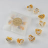 Handmade soap bars with floral toppings on a white background