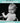 Black and white photo of a baby in a high chair with humorous birthday message on a teal background