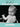 Black and white photo of a baby in a high chair with humorous birthday message on a teal background