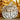 Wooden pumpkin decoration with twine on a background of autumn leaves