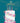 Birthday card with a floral cake and candles on a teal background, featuring text for a sister-in-law.
