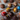 Assorted chocolate truffles with different toppings on a rustic surface
